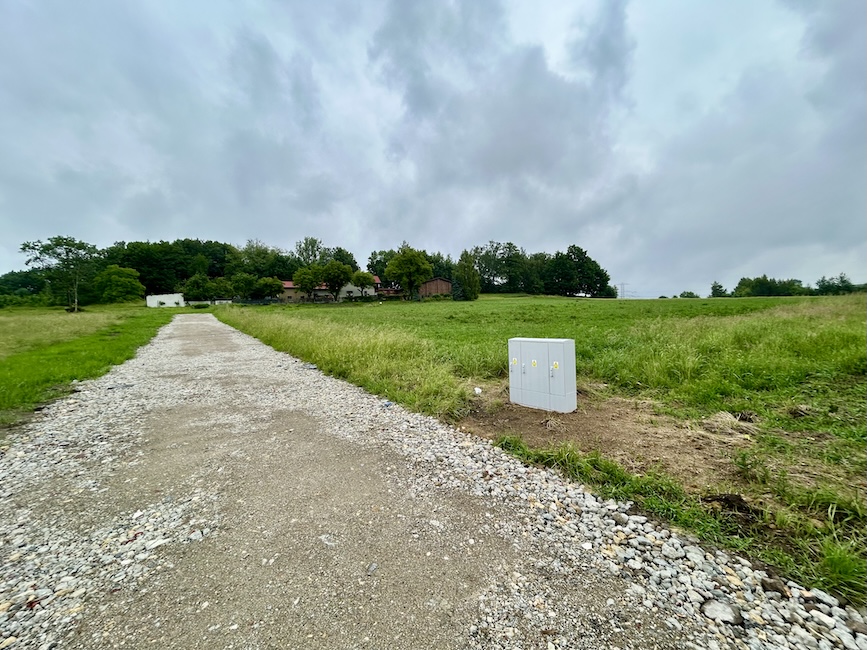 Droga dojazdowa przez sąsiednią działkę – służebność przejazdu Wąska droga żwirowa prowadząca między posesjami do działki w głębi